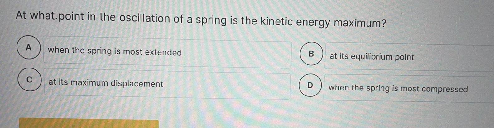 At what point in the oscillation of a spring is the kinetic